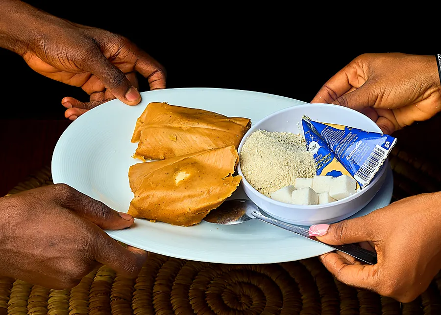 Moi moi, garri, milk and sugar being served on a plate